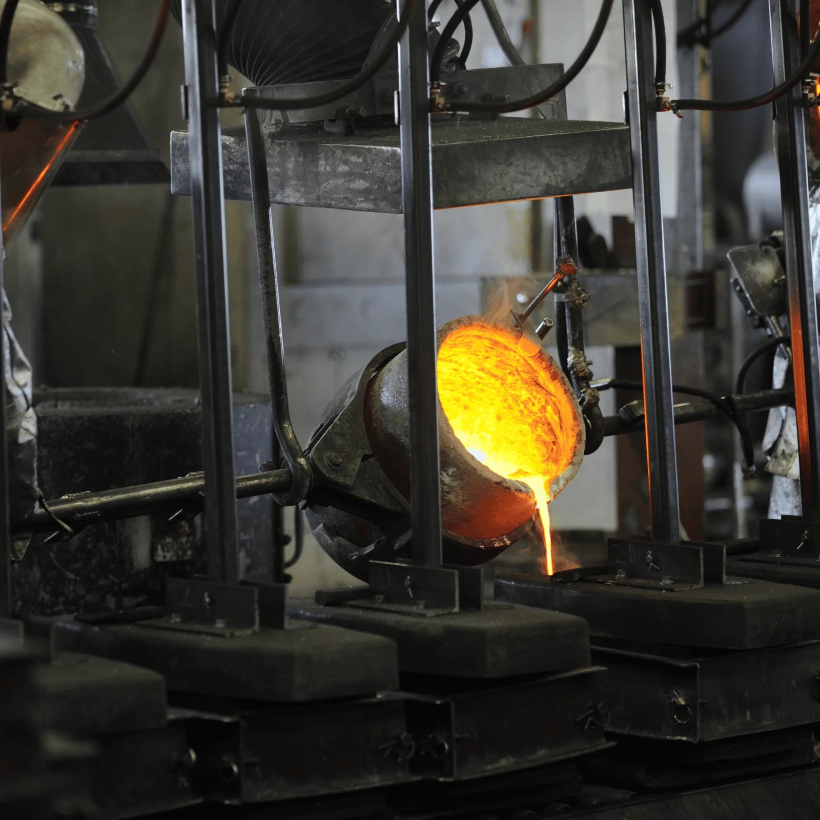 Molten bronze pouring into a mold